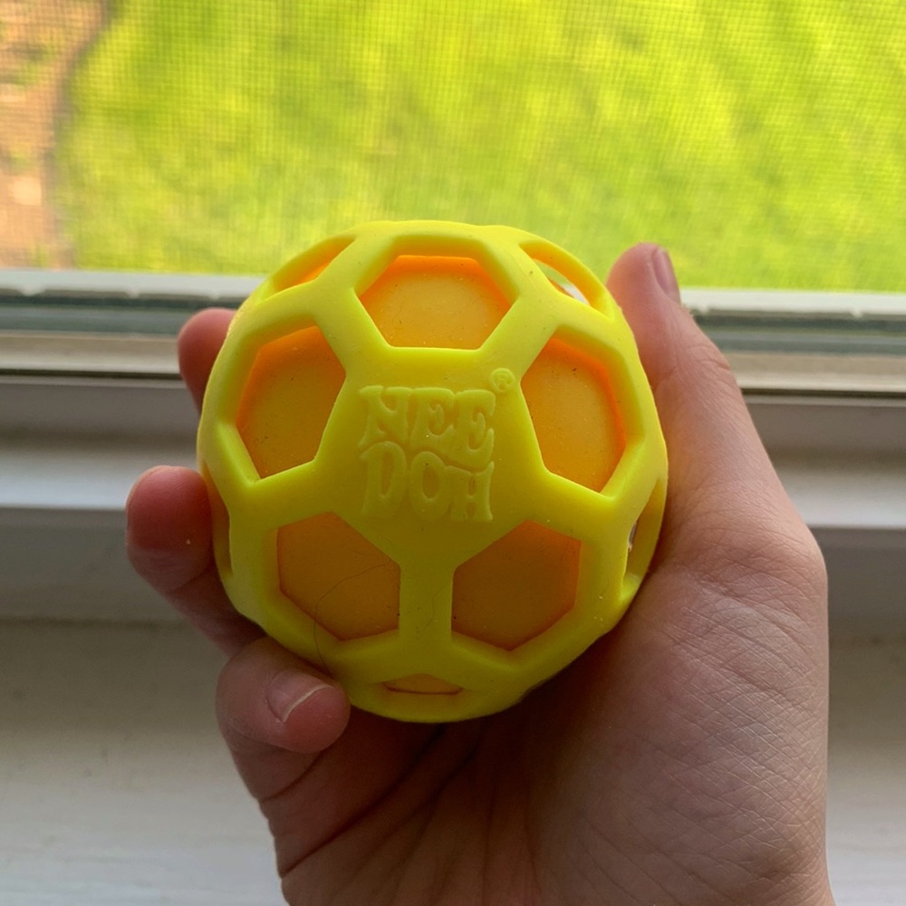 Color changing yellow to orange atomic nee doh stress ball